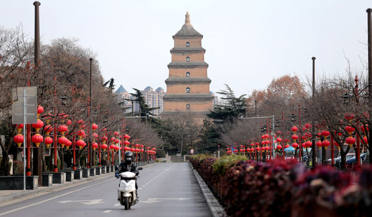 A rider travels on an empty road in Xian